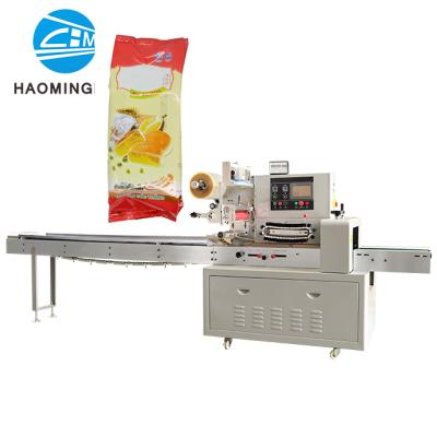 China Semi-automatic food milk chocolate bar flow packing machine save cost and labor for sale