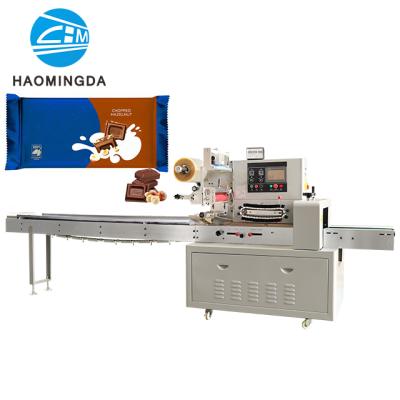 China Semi-automatic food milk chocolate bar flow packing machine save cost and labor for sale