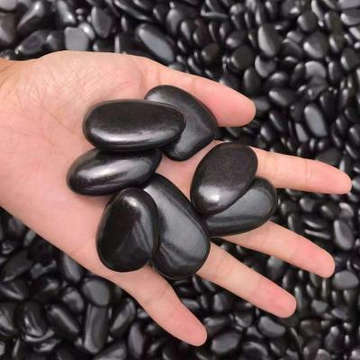 China Traditional high quality polished and waxed natural black pebbles for sale