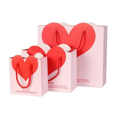 China New Disposable Shopping Bag Red Heart Shaped White Gift Handle Cardboard Design Packaging Paper Bags for sale