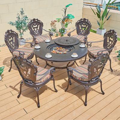 China Waterdichte villa ronde patio eetkamer tuin gegoten aluminium barbecue tafel en 6 stoelen Te koop