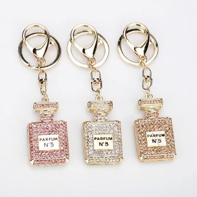 China 2022 Creative New Arrivals Metal Perfume Bottle Key Chain Crystal Rhinestone Keychain Ring Women Bag Charm for sale