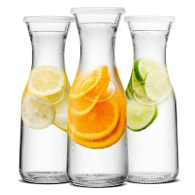 China Modern Narrow Neck Beverage Milk Water Dispenser Bottle Glass Carafe With Lids for sale