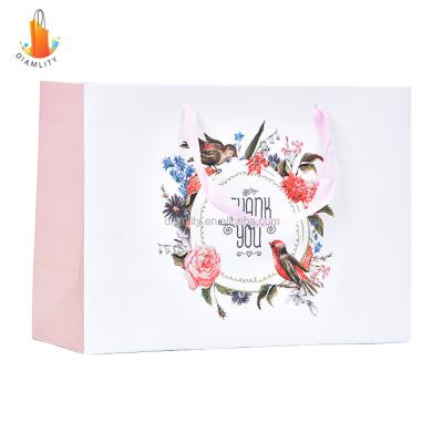 China Recyclable custom luxury clothing retail bag packing bolsas de papel pink shopping bag gift packaging paper bags with handles for clothes for sale