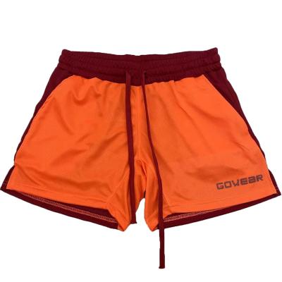 China Anti-Wrinkle Athletics Mesh Fabric Men Shorts Solid Color Patch Sports Drawstring Over The Knee Mens Athletics Trunks for sale