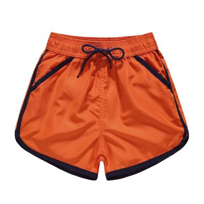 China New arrival factory supply kids beach wear solid color contrast patchwork boy non-toxic beach shorts quick dry swim trunks for sale