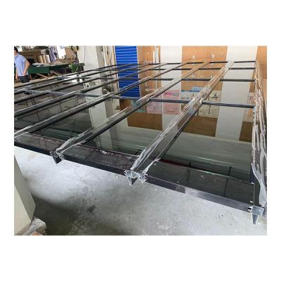 China Heat Insulation Black Aluminum Frame Black Tempered Glass Panel Garage Door for sale