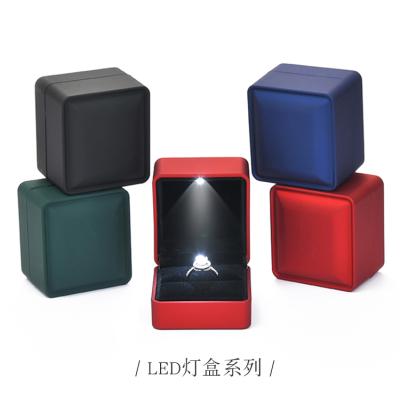 China Luxury Custom PU Leather Ring Pendant Packaging Led Light Leather Jewelry Ring Box Led Light Jewelry Box Packaging for sale