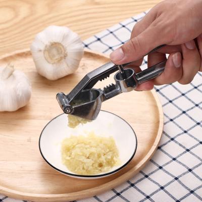 China Viable Durable Food Accessories Garlic Crusher Kitchen Hand Held Garlic Press With Comfortable Handle for sale