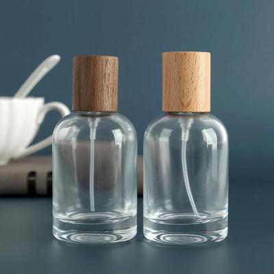 China Personal Care Empty Luxury 50ml Clear Perfume Bottle With Wooden Cap for sale