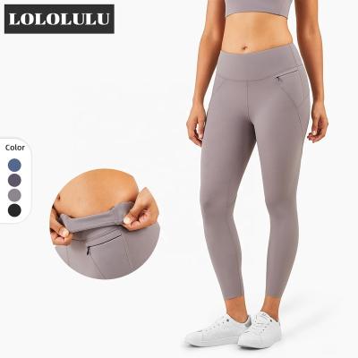 China Breathable Amazon High Waist Fitness Gaiters With Sexy Pocket Hip Line Compression Pants For Women for sale