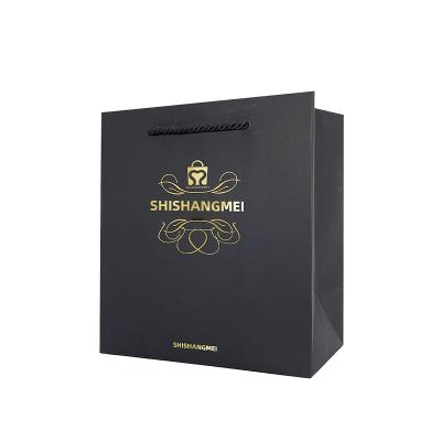 China Custom Recyclable Printed Black Gold Foil Logo Packaging Square Bottom Gift Paper Bag With Cotton Handles for sale