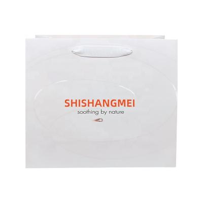 China Customized Recyclable Logo Cosmetic Boutique White Matte Lamination UV Printed Paper Bags With Satin Rope Handles for sale