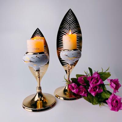 China Wholesale home table candle holder single candle holder gold metal office cafes hotel metal leaf shape hollow desk decoration for living room for sale