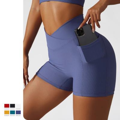 China Seamless Cross Waist Hip Lift Yoga Shorts With Pocket Cycling Running Fitness Pants High Waist Tight Running Shorts for sale