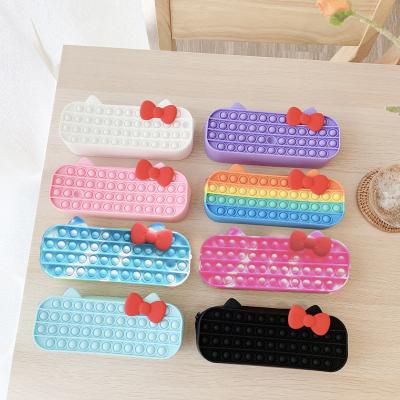 China DDA2340 Silicone Kids Educational Toys Wiggle Pen Pencil Case Zipper Bag Sensory Bubble Bowknot Silicone Wiggle Person Pencil Cases for sale