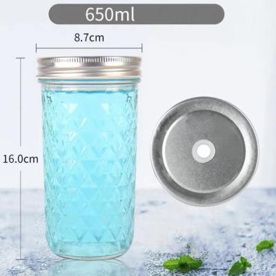 China Freshness Preservation 650ml Diamond Embossing Glass Mason Jar With Lid And Straw for sale