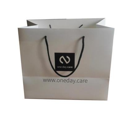 China Recycled Materials Custom Printing White Cardboard Paper Bag With Logo For Packaging for sale