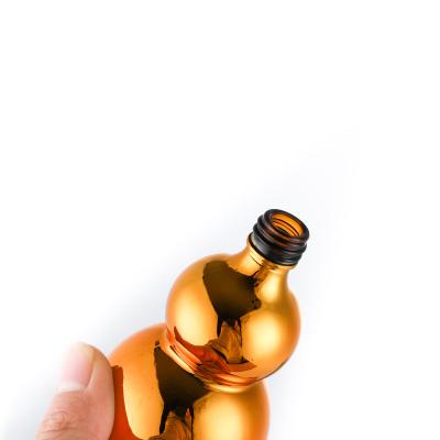 China Cosmetic Gold Bottle Gourd Bottle 30ml Essential Oil Dropper Bottle Electroplating Glass Bottle for sale