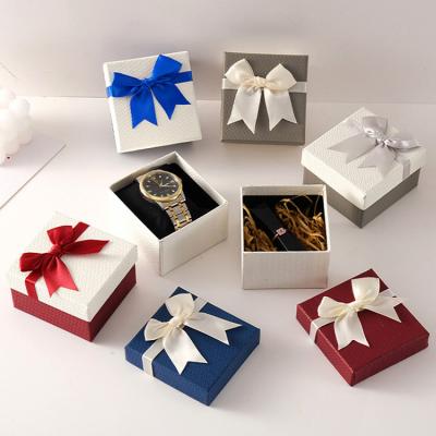 China Recyclable Hot Selling Mystery Logo Paper Watch Box Cosmetic Flower Bow Ribbon Jewelry Gift Custom Made Watch Box With Lip Gloss Packaging for sale