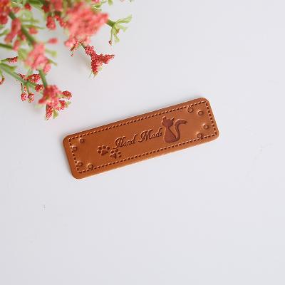 China Sustainable Handmade embossed custom pu leather labels tags for garment jeans for sale