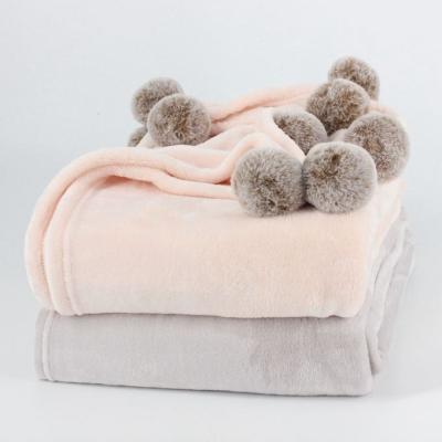 China Warm Solid Anti-bacteria Amazon Flannel Fleece Blanket With Pompoms for sale