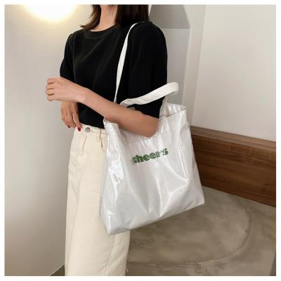 China Hot Sale Cheap Stylish Designer Handled Fashion College Cear Recycle Tote Waterproof PVC Shopping Bag for sale