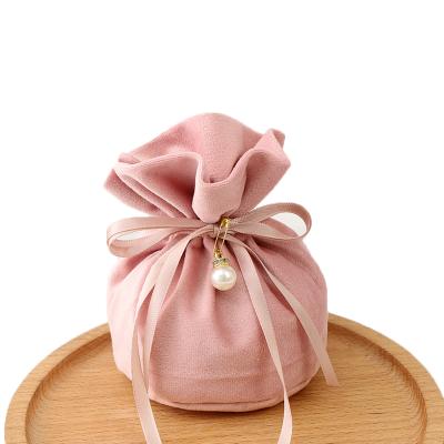 China Drawstring Round Bottom Pink In Color Flannel Jewelry Drawstring Bags Earphone Running Gift Bag for sale