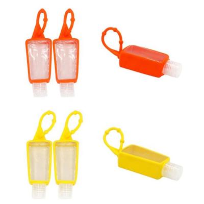 China Popular Kids Travel Keychain Flip Top Empty Silicone Hand Sanitizer Bottle Mini Small With Hook for sale