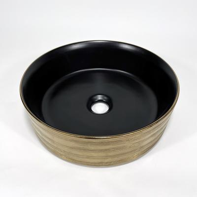 China Modern Design Hotel Wash Basin Vessel Round Sink Luxury Brushed Luxury Matte Black And Mounted Gold Ceramic Bathroom Sink for sale