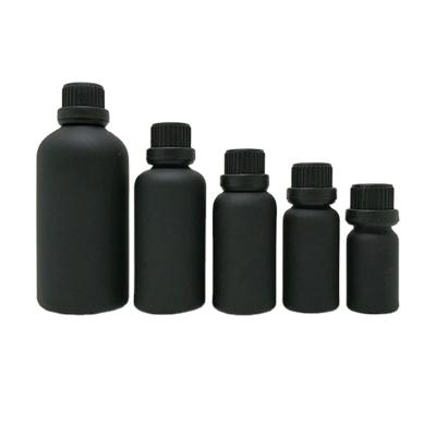 China Custom Printing Matte Black Cosmetic Packaging 10ml 30ml 50ml Round Shape Essential Oil Glass Bottle With Cap for sale