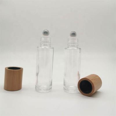 China Custom Logo 15ml Personal Care Essential Oil Bamboo Cap Free Sample Clear Glass Roll On Bottle For Eye Cream for sale