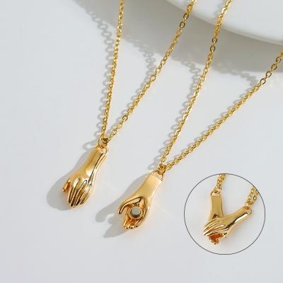 China Cute 18k Gold Plated Brass Magnet Couple Hand Shake Pendant Necklace for sale