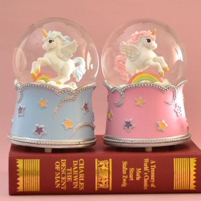 China Resin + 100mm Glass Custom Color Resin Glowing Unicorn Snow Globe Music Box for sale