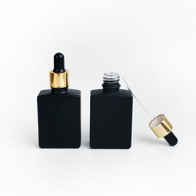 China Cosmetic 30ml Square Pipette Black Glass Serum Bottles Essential Oil Rectangle Glass Dropper Bottles With Gold Pipette Cap for sale