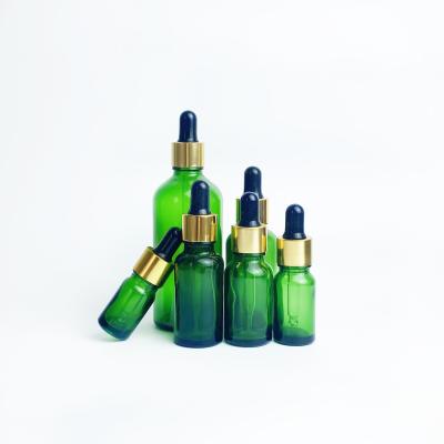 China Cosmetic essential oil dropper bottle 30ml 50ml 100ml green dropper bottle 30ml 50ml 100ml green liquid glass packaging for sale