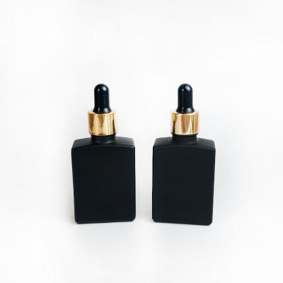 China Cosmetic 30ml matte frosted black rectangle square dropper glass bottle with gold screw cap for essential oil e liquid for sale