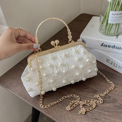 China Wholesale High Quality Custom Handbags For Women 2021 Fashion Pearl Luxury Handbags Women's Bag Clip Korean Metal Version Tote Bag for sale