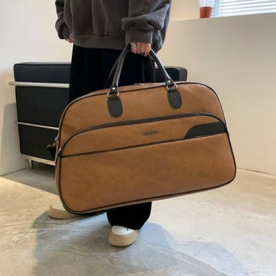 China Durable Travel Bags Hand Suitcase Designer Duffel Bag New Fashion Solid Color Large Capacity PU Leather Travel Luggage Bag 2022 for sale