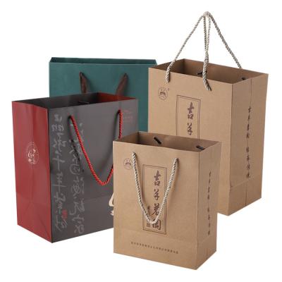 China Customized Logo Printed Brown Kraft Packaging Recyclable Paper Bag Packaging Custom Bag With Ribbon Handles for sale