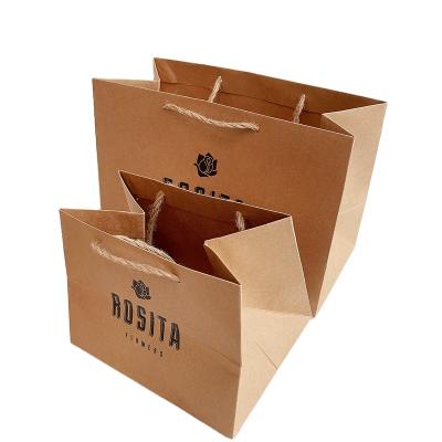 China Newest sale custom black kraft paper packaging bag disposable logo clothing packaging bag for sale