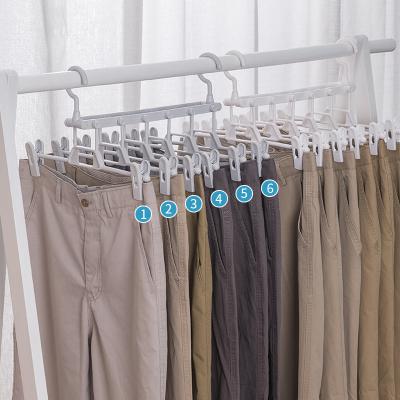 China Modern Folding Plastic Multi Layer Trouser Hanger Closet Storage Pants Racks Clip Hanger for sale