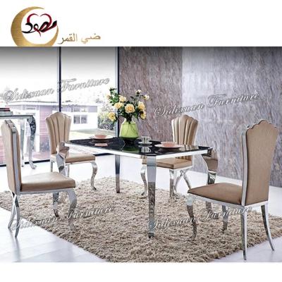 中国 Four legs tempered glass top rectangle luxury dining table and chair set 販売のため