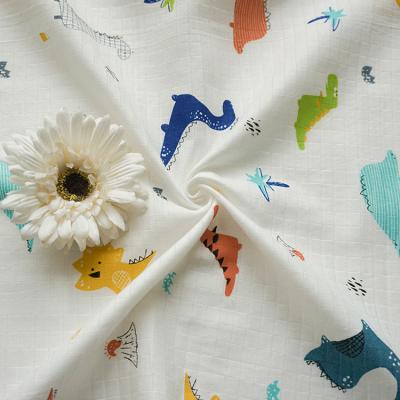 China Jacquard Style Anti-Static Baby Textile Good Quality Dinosaurs Block Printing Soft Cotton Muslin Fabric for sale