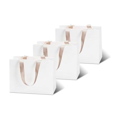 China Bolsa de papel de impresión de logotipo personalizado para ropa y boutiques en venta