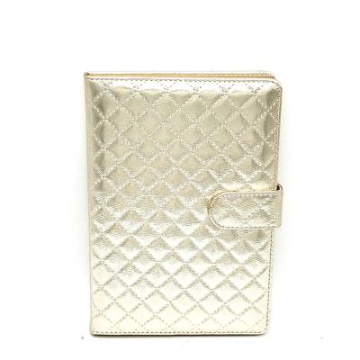 China Gold PU Leather Soft Cover Magnetic Grid Embossed Notebook With Magnet Closure for sale