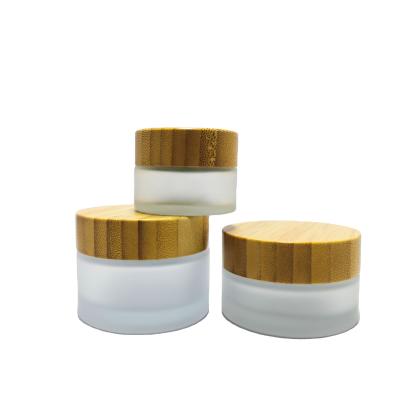 China Skin Care Creams Eco - Friendly Cosmetic Bamboo Lid Glass Frosted Clear Cream Jar With Wooden Cap for sale