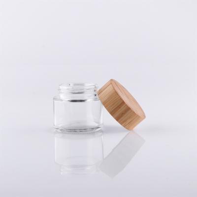 China Cosmetic the hottest selling exquisite portable bamboo and wooden pressure rotary glass jar for sale