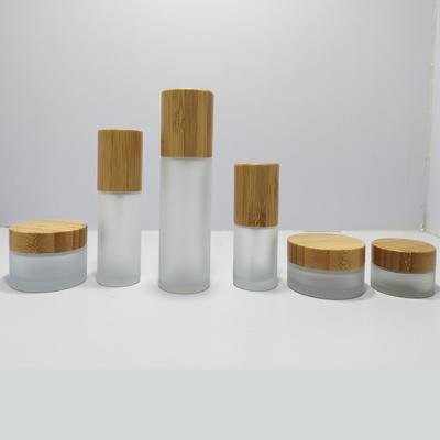 China Wholesale 1oz 2oz 3oz 4oz Glass Jar Packaging Bamboo Cream Jar With Bamboo Lid for sale