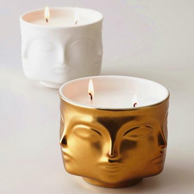 China Wholesale Modern Wedding Ceramic Empty Candle Jars Head Table Luxury Face Golden Buddha Container Home Decor Candle Jars for sale